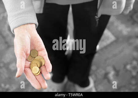 Poor society elderly hand of senior person full of worthless bronze coins Stock Photo