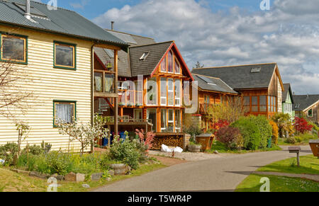 FINDHORN FOUNDATION ECO COMMUNITY  COLOURFUL WOODEN ECO HOUSES AND THE GARDENS IN SPRINGTIME Stock Photo