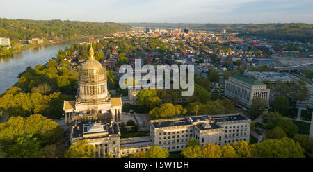 Sunrise reflects in the Kanawha River slowly flowing by picturesque Charleston West Virginia downtown Stock Photo