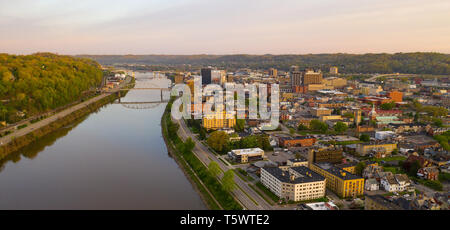 Sunrise reflects in the Kanawha River slowly flowing by picturesque Charleston West Virginia downtown Stock Photo