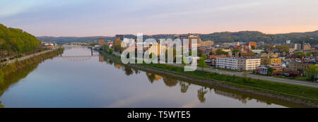 Sunrise reflects in the Kanawha River slowly flowing by picturesque Charleston West Virginia downtown Stock Photo