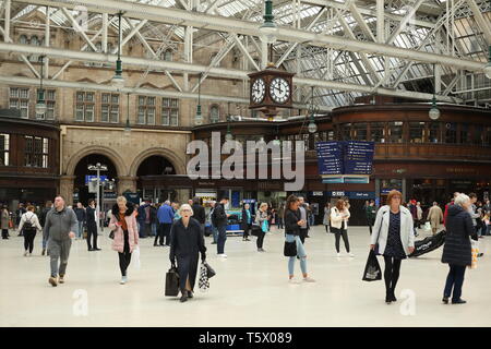 people rush through central station with large victorian clock Stock Photo