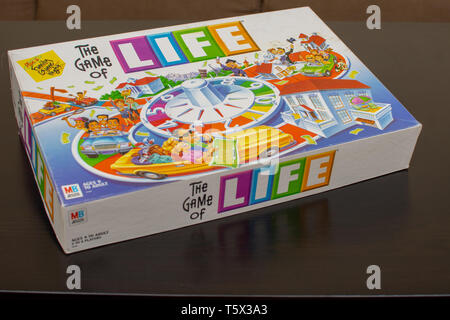 'RAK, RAK, UAE - 4/20/2019 : Colourful Game of Life Box set out on the table for some family fun for all ages strategizing with this Milton Bradley cl
