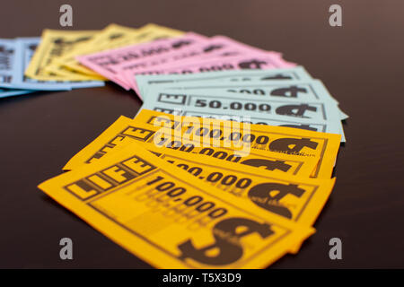 'RAK, RAK, UAE - 4/20/2019 : Colourful Game of Life  Money fanned out on the table. Family fun for all ages strategizing and having fun with this Milt