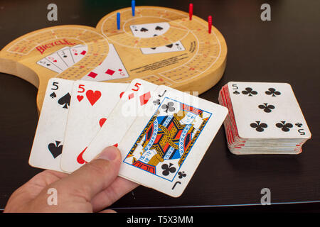 RAK, RAK/UAE - 4/20/2019: 'Player view of a Cribbage card game and board up close looking at the blue and red pegs with an excellent best card hand of Stock Photo