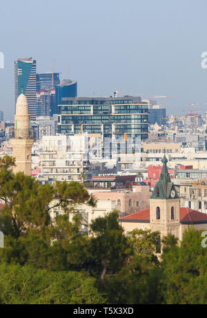 Skyline of Tel Aviv, Israel, as seen from Jaffa, with the Jaffa clock tower and the Al Bahr Mosque Minaret in the front Stock Photo