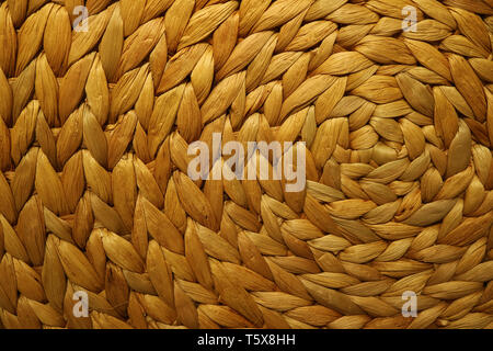 Texture and pattern of a golden brown color woven water hyacinth place mat Stock Photo