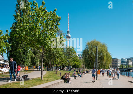 Berlin, Germany - April, 2019: People enjoying sunny weather in public park next ro riverside in Berlin, Mitte Stock Photo