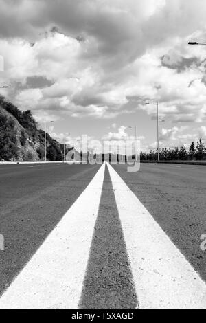 Empty street to big city. Black and white photo. Vertical composition Stock Photo