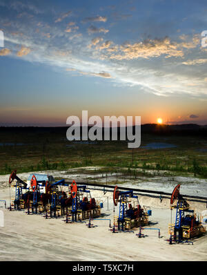 Beautiful sunset on oil extraction field in West Siberia. Russia oil and gas industry. Business and nature Stock Photo