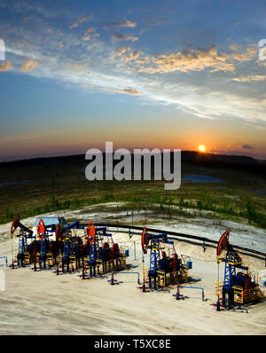 Beautiful sunset on oil extraction field in West Siberia. Russia oil and gas industry. Business and nature Stock Photo
