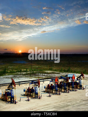 Beautiful sunset on oil extraction field in West Siberia. Russia oil and gas industry. Business and nature Stock Photo