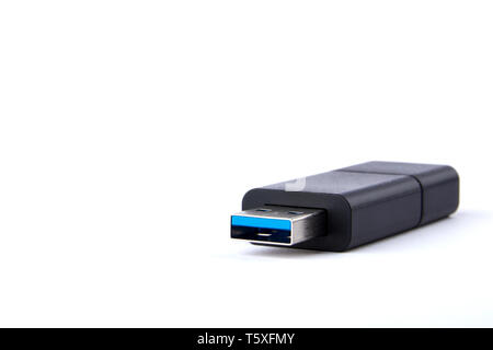 Detailed view of black USB flash drive with silver blue connector. Photo on white background with space for your text. Stock Photo