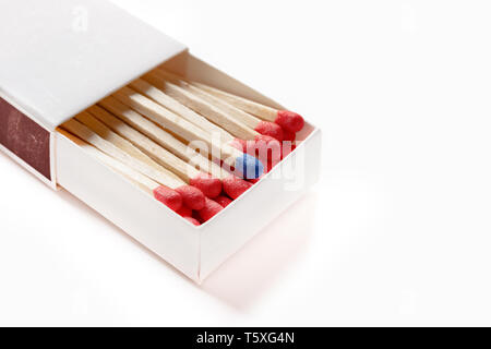matchbox with one blue matchstick other in red on white with clipping path Stock Photo