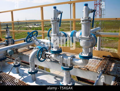 Group valves control the oil production on oil and gas refinery plant. Oil industry Stock Photo