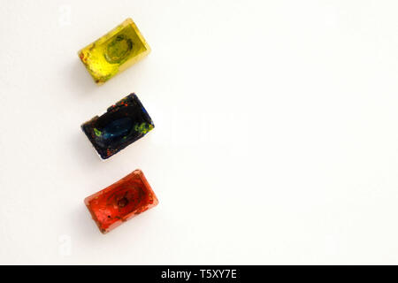 Bright colorful watercolor paints on a white background. Close-up watercolor tray. Flat lay, top view, copy space. School and creativity concept. Stock Photo