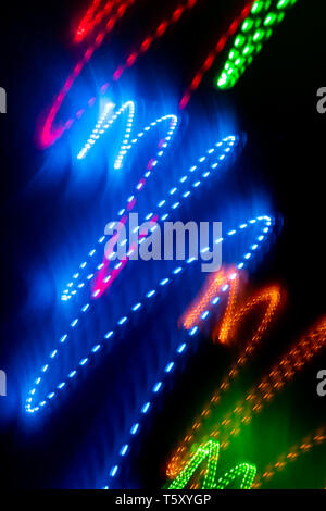 Multicolored glowing zigzag smooth lines on black background.  Stock Photo