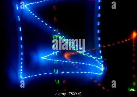 Glowing blue square of neon lines on black background. Stock Photo