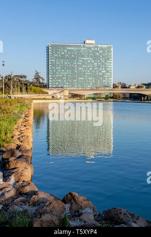 Rome, Italy - March 24, 2019: Palazzo ENI, or more commonly Glass Palace is located in the EUR district of Rome, at the eastern end of the pond Stock Photo