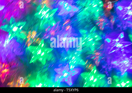 Abstract blurred luminous background of bright star-shaped neon lights. Stock Photo