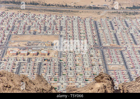 Aerial view of New housing development in Al Ain, Abu Dhabi, United Arab Emirates from Jebal Hafeet mountain top looking at same housing development Stock Photo