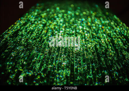 Green light passing through a stack of glass. Abstract background, bokeh Stock Photo