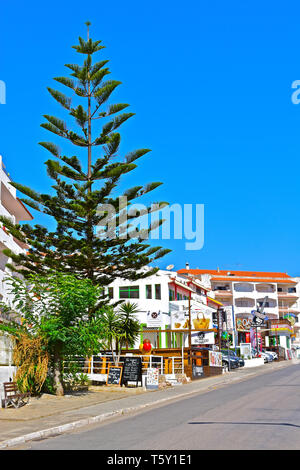 A street view of the shops on the street leading down to the harbour of this quaint fishing village. Stock Photo