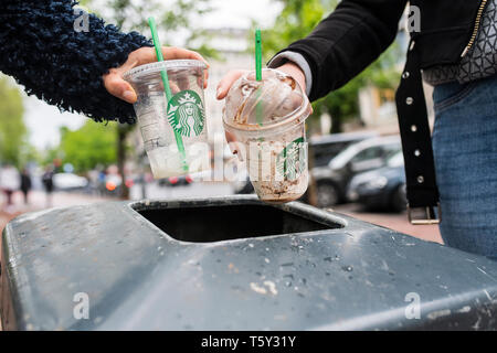 Waste of plastic cubs from Starbucks, put in a bin on the Königsallee in Düsseldorf, Germany. Stock Photo