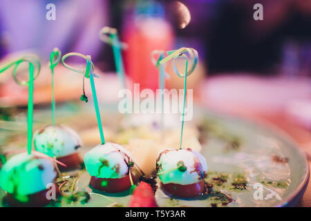 Plate with canapes and appetizers, on wooden plate. Wedding party. Stock Photo