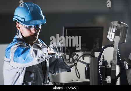 Lathe Metalworking Worker. Caucasian Machine Operator. Industrial Theme. Stock Photo