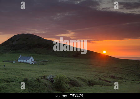 Mwnt church and hill at sunset. Stock Photo