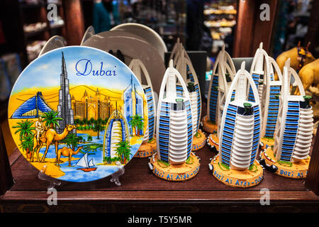 DUBAI, UAE - MARCH 02, 2019: Souvenir plate with Burj Khalifa Tower and Burj Al Arab Hotel model in the duty free zone in the Dubai International Airp Stock Photo