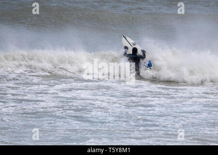 Newhaven, UK. Saturday 27 April 2019.  Surfers make the most of the waves in the sheltered Newhaven harbour as Storm Hannah hits the Sussex coast, © Jason Richardson / Alamy Live News Stock Photo