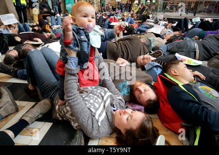 Glasgow, Scotland, UK 27th April, 2019. Kelvingrove Art Galleries and Museum saw a copycat protest at climate change to the blue whale in London as dippy the Diplodocus saw an Extinction Rebellion Climate change protesters lie down protest ie “die- in” through earth being poisoned. Gerard Ferry/Alamy Live News Stock Photo