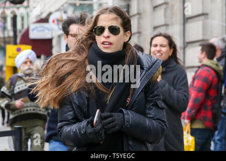London, UK. 27th Apr 2019.  A woman in Trafalgar Square on a cold and windy day in London.   Credit: Dinendra Haria/Alamy Live News Stock Photo
