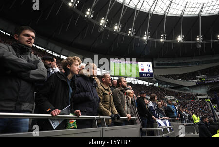 London, UK. 27th Apr 2019. Tottenham fans behind the goaline stand up in the stand at the Tottenham Hotspur v West Ham United English Premier League match, at The Tottenham Hotspur Stadium, London, UK on April 27, 2019. **Editorial use only, license required for commercial use. No use in betting, games or a single club/league/player publications** Credit: Paul Marriott/Alamy Live News Stock Photo