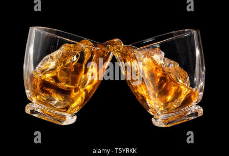 glasses of whiskey making toast Stock Photo