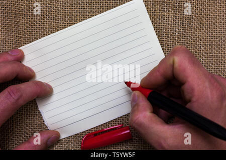 Business Empty template for Layout for invitation greeting card promotion poster voucher. Man s is hand hold white paper with symbolic letter jute sac Stock Photo