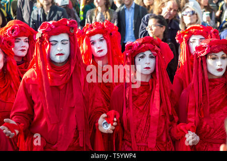 Red brigade environmental activists dressed as blood tears representing the tears of the Earth - Closing Ceremony of the Extinction Rebellion protest Stock Photo
