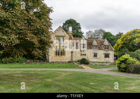 A view across the village green to Armada House which dates from 1588; Weston, Northamptonshire, UK Stock Photo