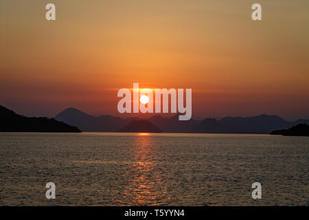 Sunset over the Pacific near Komodo Island in Indonesia Stock Photo