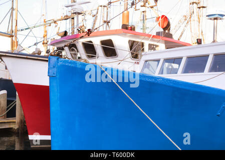 Blue and red fishing boats docked in the inner harbor on Lewis Bay in Hyannis Massachusetts  new england. Stock Photo