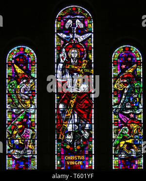 Stained Glass in the Basilica Sacre Coeur in Paris, France, depicting Jesus Christ and the symbols of the Four Evangelist with the words Christ Conque Stock Photo