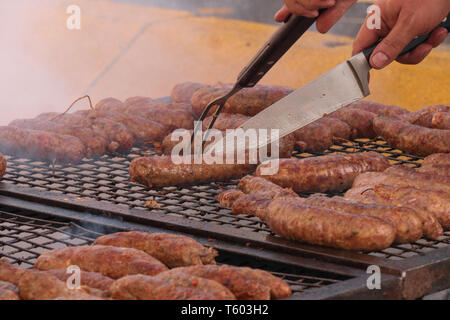 Typical Argentine chorizo grilled in the street. It is consumed as the traditional 'choripan', chorizo sandwich and French bread. Argentinean meat. Stock Photo