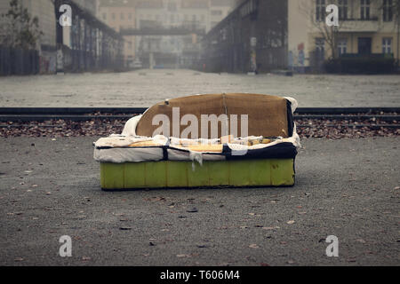 Old sofa in a dirty City Stock Photo