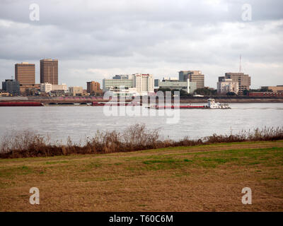 Port Allen, Louisiana, USA - 2019: Downtown Baton Rouge is seen from across the Mississippi River as a towboat  travels upstream. Stock Photo