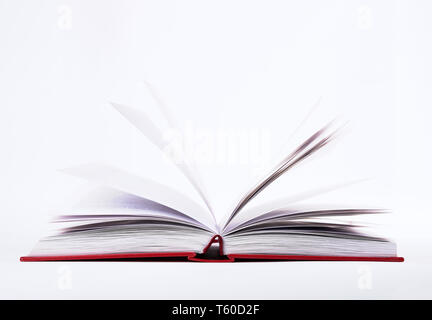 Closeup view of open book with pages in red hard cover with shadow, isolated on white background Stock Photo