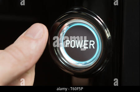 Male finger pushing button with text Power Stock Photo