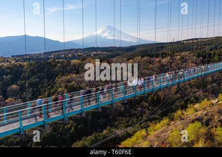 People walkin on Mishima Skywalk bridge with Mount fuji seen in the distant, clear sunny day Stock Photo