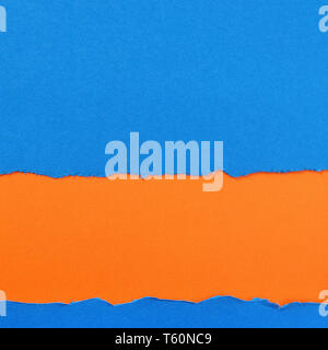 Torn blue paper strip orange background border frame Stock Photo